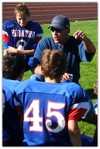 Darren donating his time coaching Pop Warner football.